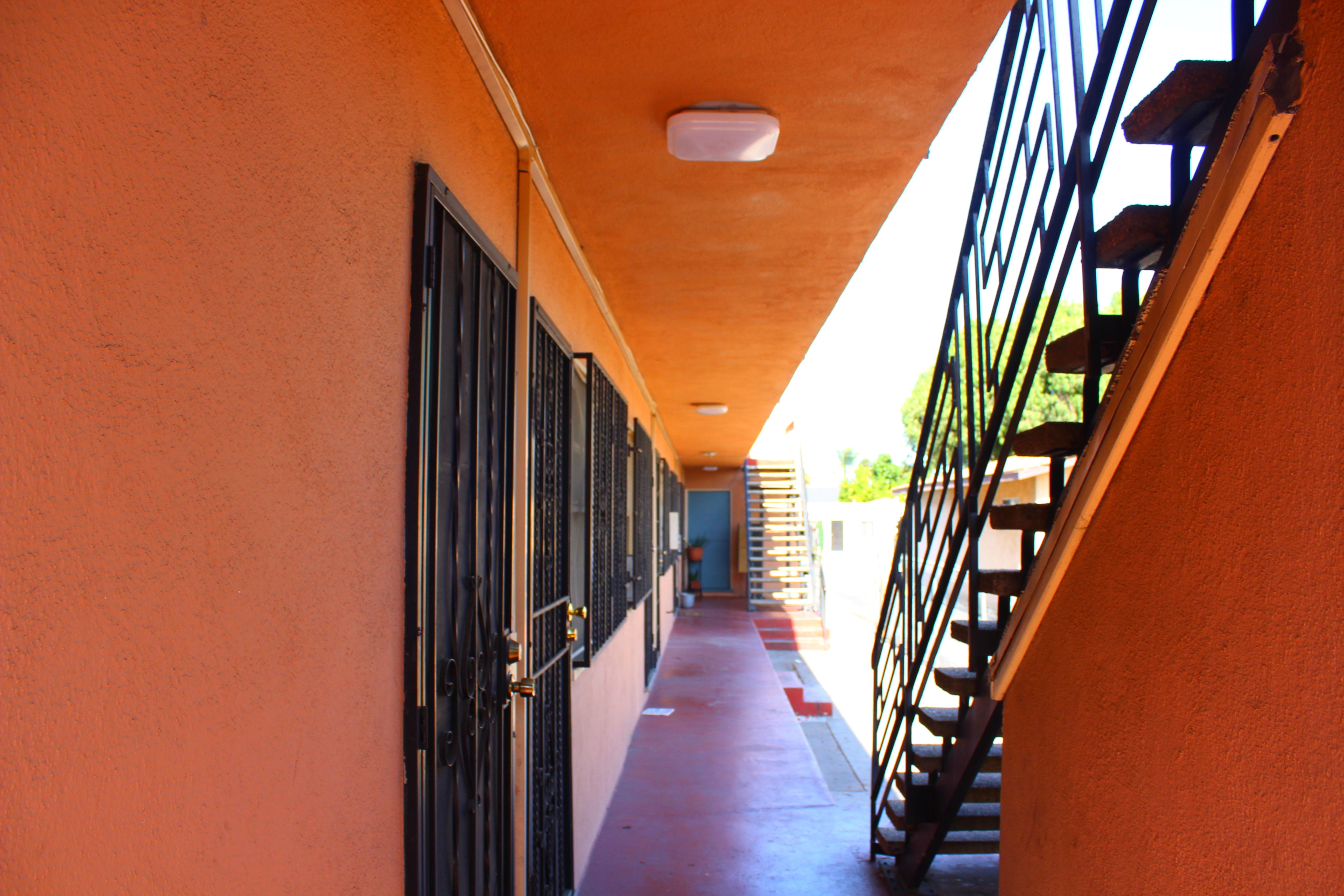 A long hallway with a staircase on the right.